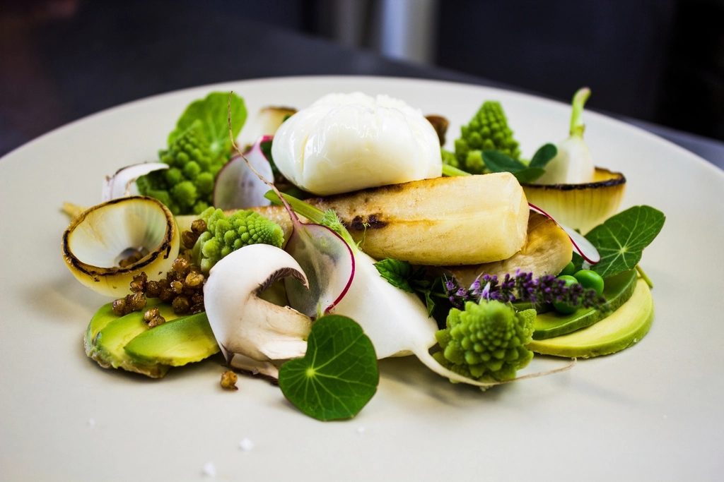 Composed plate of local vegetables and fish at Marigold