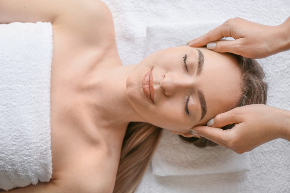 Guest receiving a head massage in a treatment room